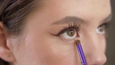 Makeup of a girl's face close-up in the studio in front of a mirror. Stock Footage 171657335