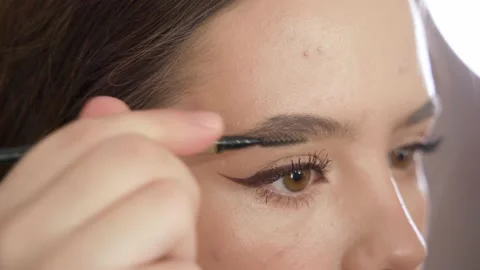 Makeup of a girl's face close-up in the studio in front of a mirror. Stock Footage 171657502