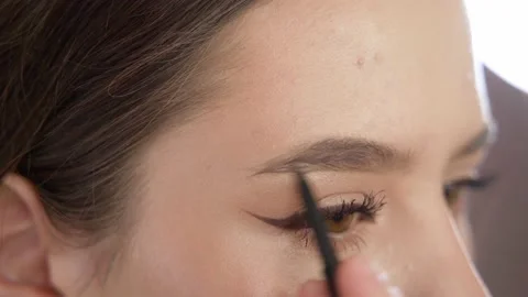 Makeup of a girl's face close-up in the studio in front of a mirror. Stock-Footage 171657613