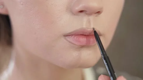 Makeup of a girl's face close-up in the studio in front of a mirror. Stock Footage 171657733