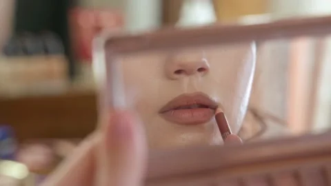 Makeup of a girl's face close-up in the studio in front of a mirror. Stock Footage 171657848