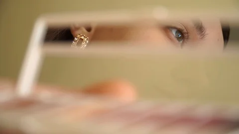 Makeup girl's reflection in a mirror making up Stock Footage 128518843