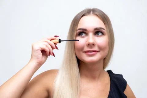 Makeup. Make-Up. Applying Mascara. Long Eyelashes. Woman applying eye mascara to Stock Photos