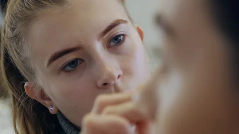 Makeup making process. Makeup artist works with a brush on the model's face Stock Footage 166921236