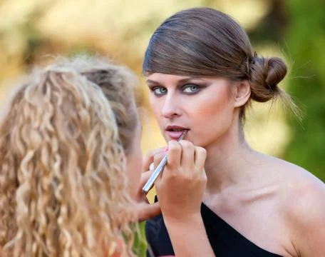 Makeup master applying lipstick with brush Foto stock