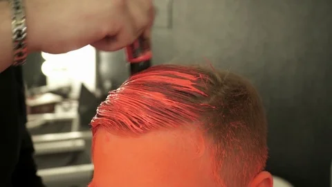 Makeup master covers model's hair with the orange color, closeup Stock Footage 73519241