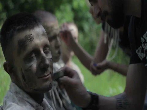 Makeup master creates zombie in the open air. Stock Footage 77411185