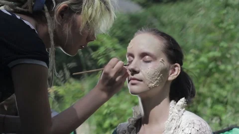 Makeup master creates zombie in the open air. Stock Footage 77523175