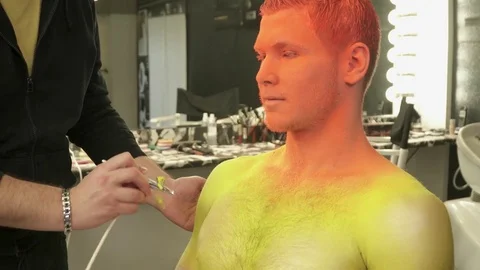 Makeup master using aerograph to color a man Video stock 73540988