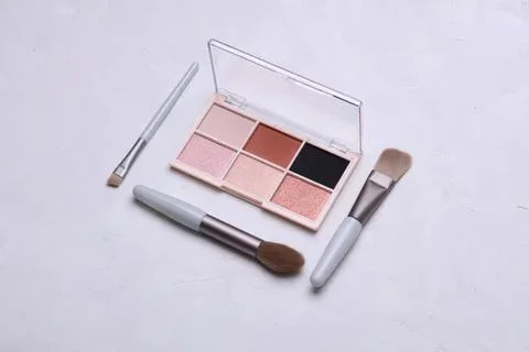 Makeup palette with brushes and applicators on white background Stock Photos