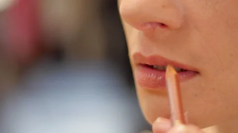 Makeup with pen on lips extreme closeup Stock Footage 59731880