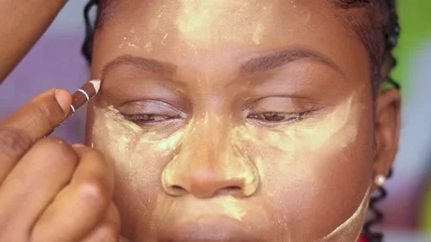Makeup pencil. Applying makeup foundation on face of a model	 Stock Footage 239588898