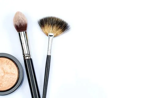 Makeup powder and brushes on white background Stock Photos
