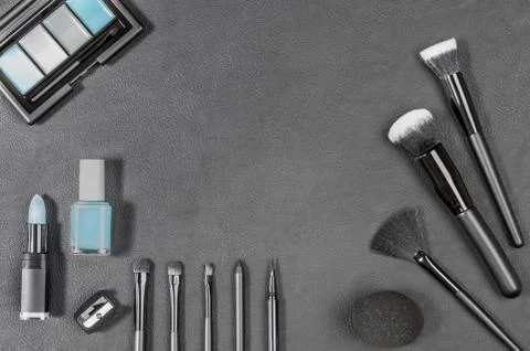 Makeup products with different brushes on black background Stock Photos