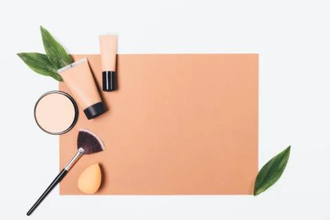 Makeup products flat lay frame on brown paper Stock Photos