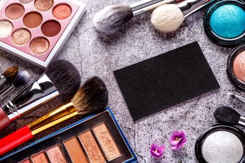 Makeup products for smooth complexion. Blank page notepad and different cosme Stock Photos