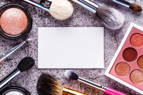 Makeup products for smooth complexion. Blank page notepad and different cosme Stock Photos