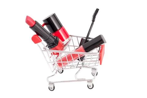 Makeup in pushcart isolated on white background. Red lipstick, mascara, pink  Stock Photos