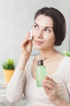 Makeup remove skin care. Closeup woman holding cotton swab and makeup remover Fotos Stock