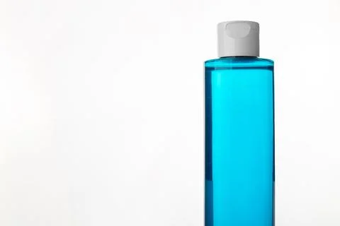 Makeup remover in plastic blue bottle isolated on white background. Natural.. Stock Photos
