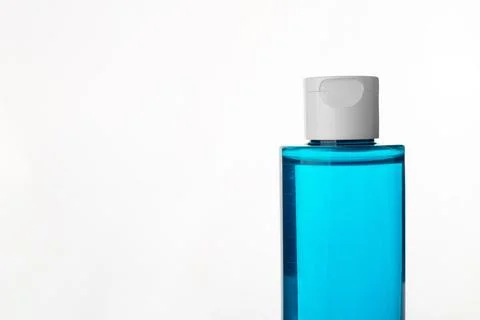 Makeup remover in plastic blue bottle isolated on white background. Natural.. Stock Photos