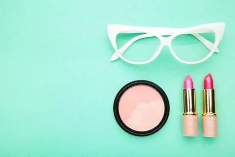 Makeup set on mint background, top view. Cosmetics Stock Photos