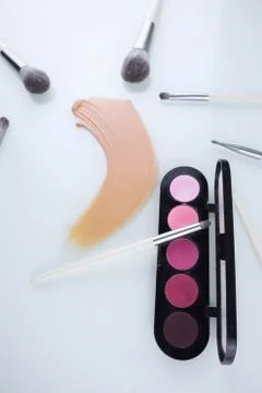 Makeup shadow palette with brushes and a smear of Foundation Stock Photos