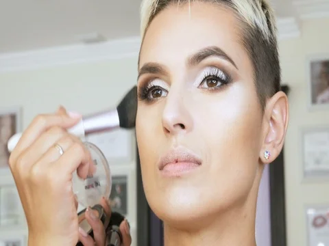 Makeup Specialist artist makes a blonde woman model beautiful Gentle makeup Stock Footage 80259145