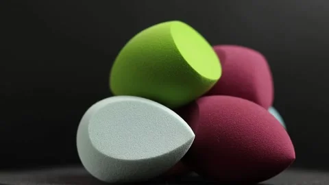 Makeup sponges on a black background Stock Footage 130346379