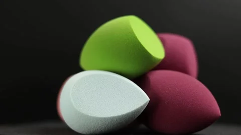 Makeup sponges on a black background Stock Footage 130346604