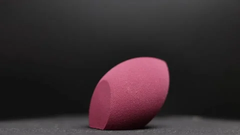 Makeup sponges on a black background Stock Footage 130346889