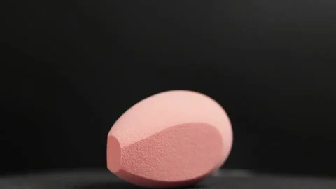 Makeup sponges on a black background Stock Footage 130347054