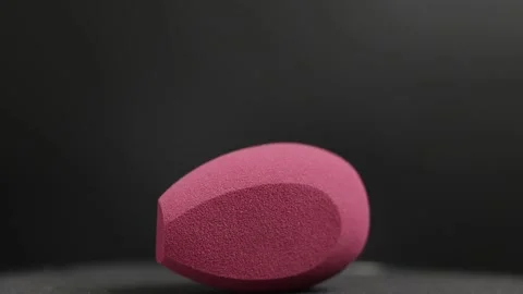 Makeup sponges on a black background Stock Footage 130347317