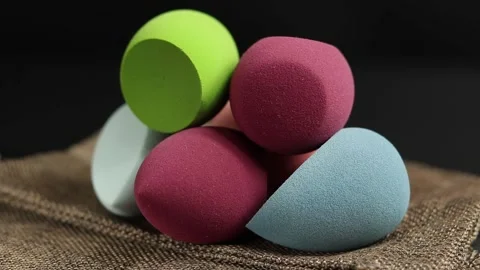 Makeup sponges on a black background Video stock 130347330