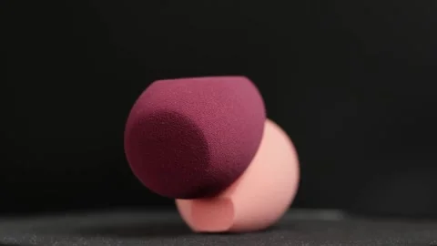 Makeup sponges on a black background Stock Footage 130347441