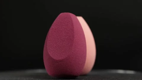 Makeup sponges on a black background Stock Footage 130347453