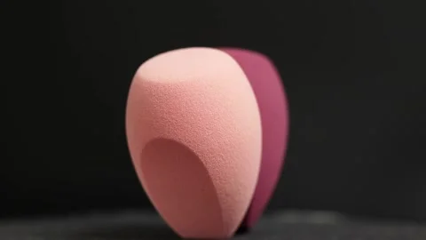 Makeup sponges on a black background Stock Footage 130347454