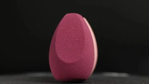 Makeup sponges on a black background Stock Footage 130347465
