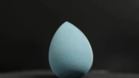 Makeup sponges on a black background Stock Footage 130347475