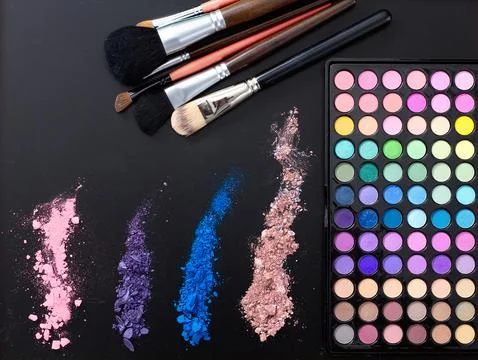 Makeup tools and accessories isolated on black background. Top view and moc.. Stock Photos