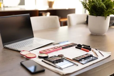 Makeup tools and laptop on table, preparing for online beauty tutorial at home Stock Photos