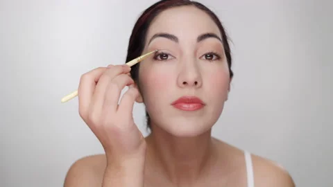 Makeup Tutorial: Beautiful hispanic model shows how to apply eye shadow Stock Footage 193650653