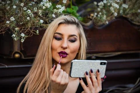 Makeup tutorial fashion blog. sexy lady put lipstick on lips. cosmetics and Stock Photos