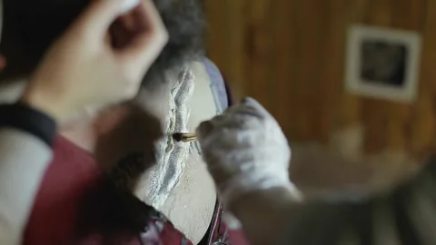 Makeup woman makes makeup in form of torn bloody wound on man Video stock 132992032