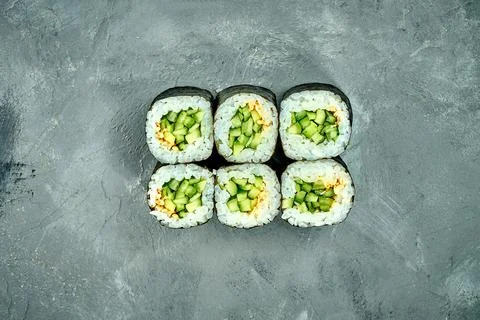 Maki sushi roll with cucumber on a gray background. Selective Focus. Sushi Me Stock Photos