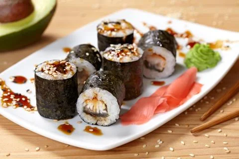 Maki sushi roll with eel, wasabi, ginger and nori seaweed Stock Photos