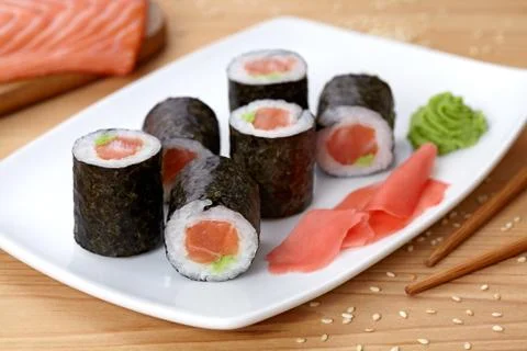 Maki sushi roll with salmon, wasabi, ginger and nori seaweed Stock Photos