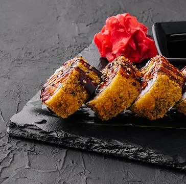Maki Sushi set on dark pattern background Stock Photos