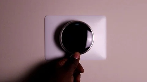 Making adjustments to a smart thermostat. Stock Footage 120453732