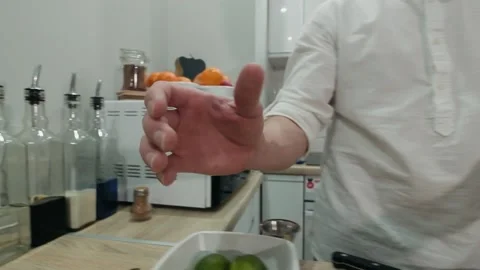 Making alcoholic cocktail. The bartender removes the lid from the shaker Stock Footage 131546066